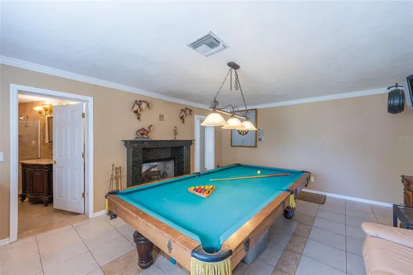 a room with pool table and a chandelier