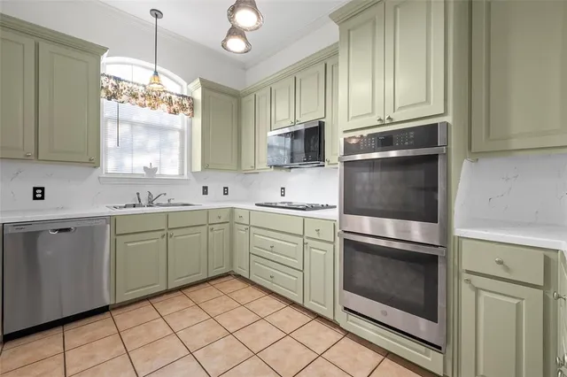 a kitchen with a sink cabinets and stainless steel appliances