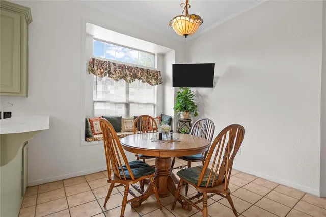 a view of a dining room with furniture and window