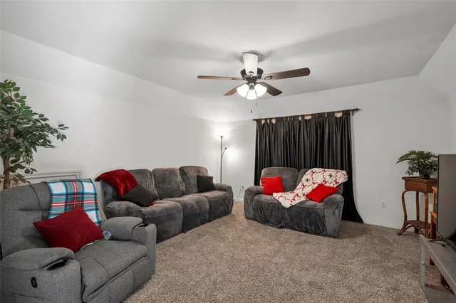 a living room with furniture a rug and a chandelier