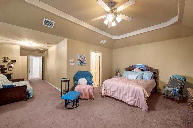 a bedroom with bed and a chandelier