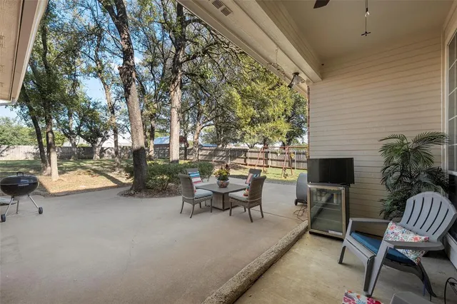 a view of a patio with table and chairs and potted plants