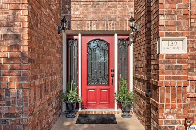 a view of a brick building with a red door and front door