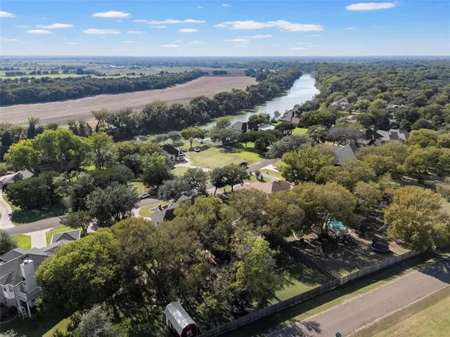 an aerial view of residential houses with outdoor space and river