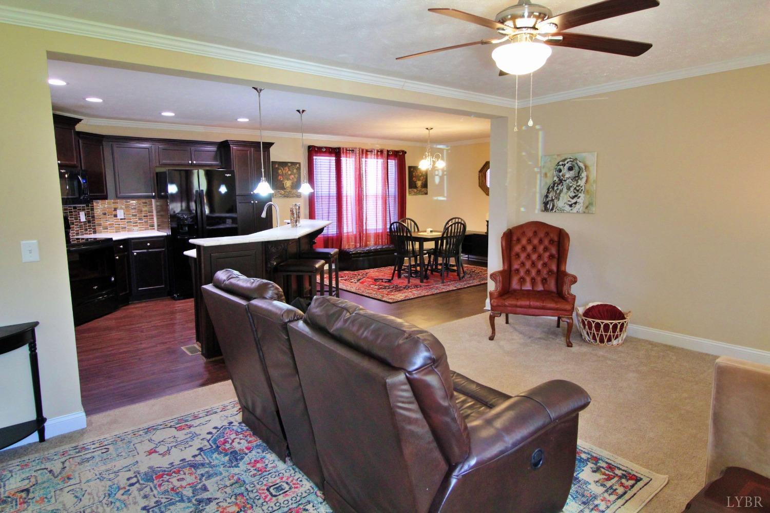 144 Rocky Road Rustburg, VA 24588 - Photo 4 of 34 a living room with furniture a dining table and paintings on the wall