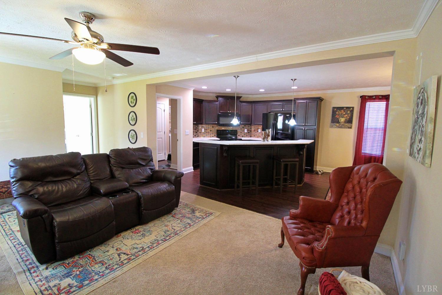 144 Rocky Road Rustburg, VA 24588 - Photo 6 of 34 a living room with furniture and a chandelier