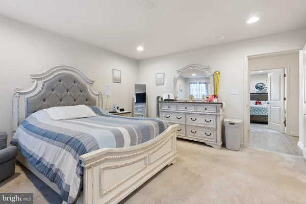 a spacious bedroom with a bed and a cabinets