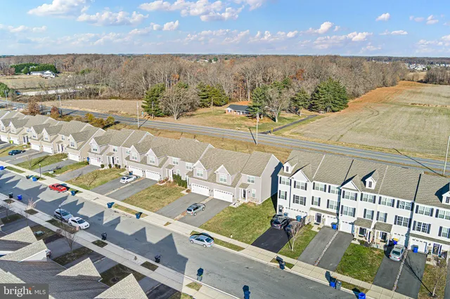 an aerial view of a house with outdoor seating
