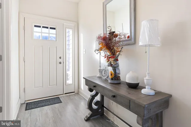 a dining room with furniture and a potted plant