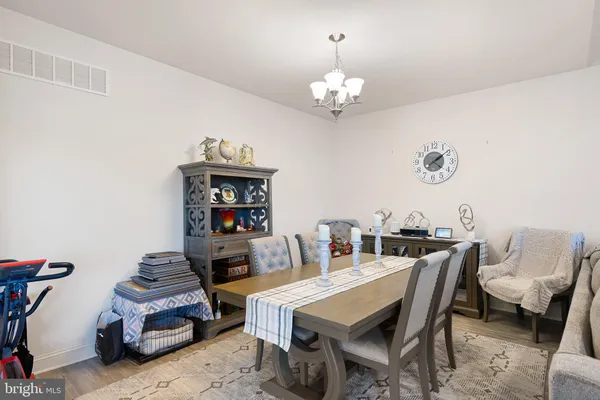 a dining room with a table chairs and a chandelier
