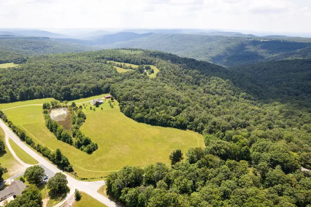 a view of a swimming pool and mountains in the background
