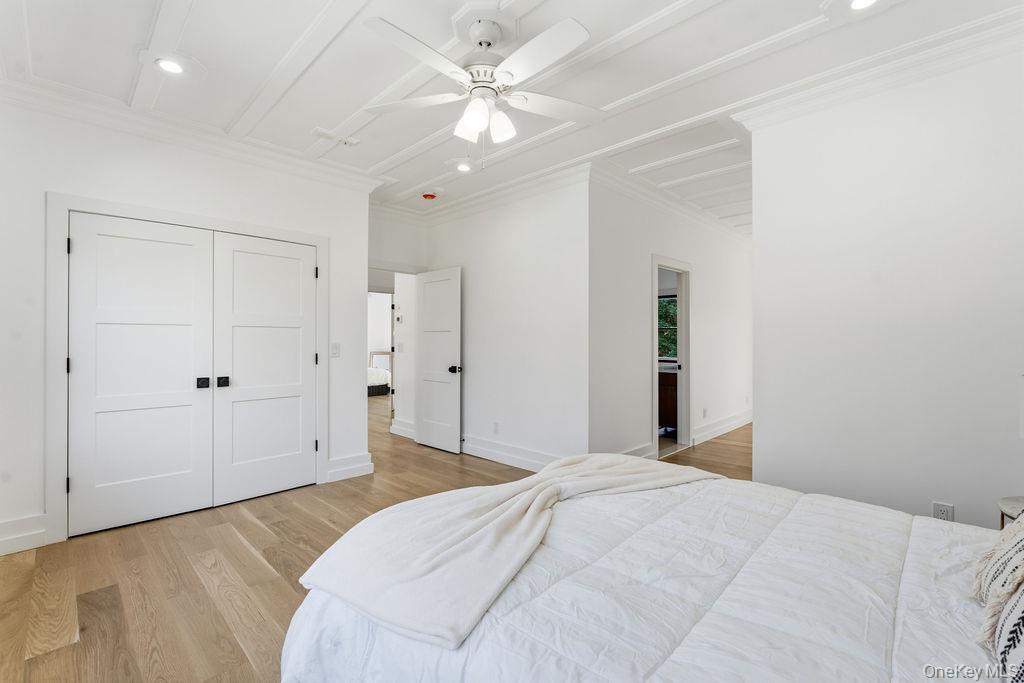 768 Bridgehampton Sag Harbor Bridgehampton, NY 11932 - Photo 16 of 35 Bedroom featuring light wood-style floors, ceiling fan, a closet, recessed lighting, and crown molding