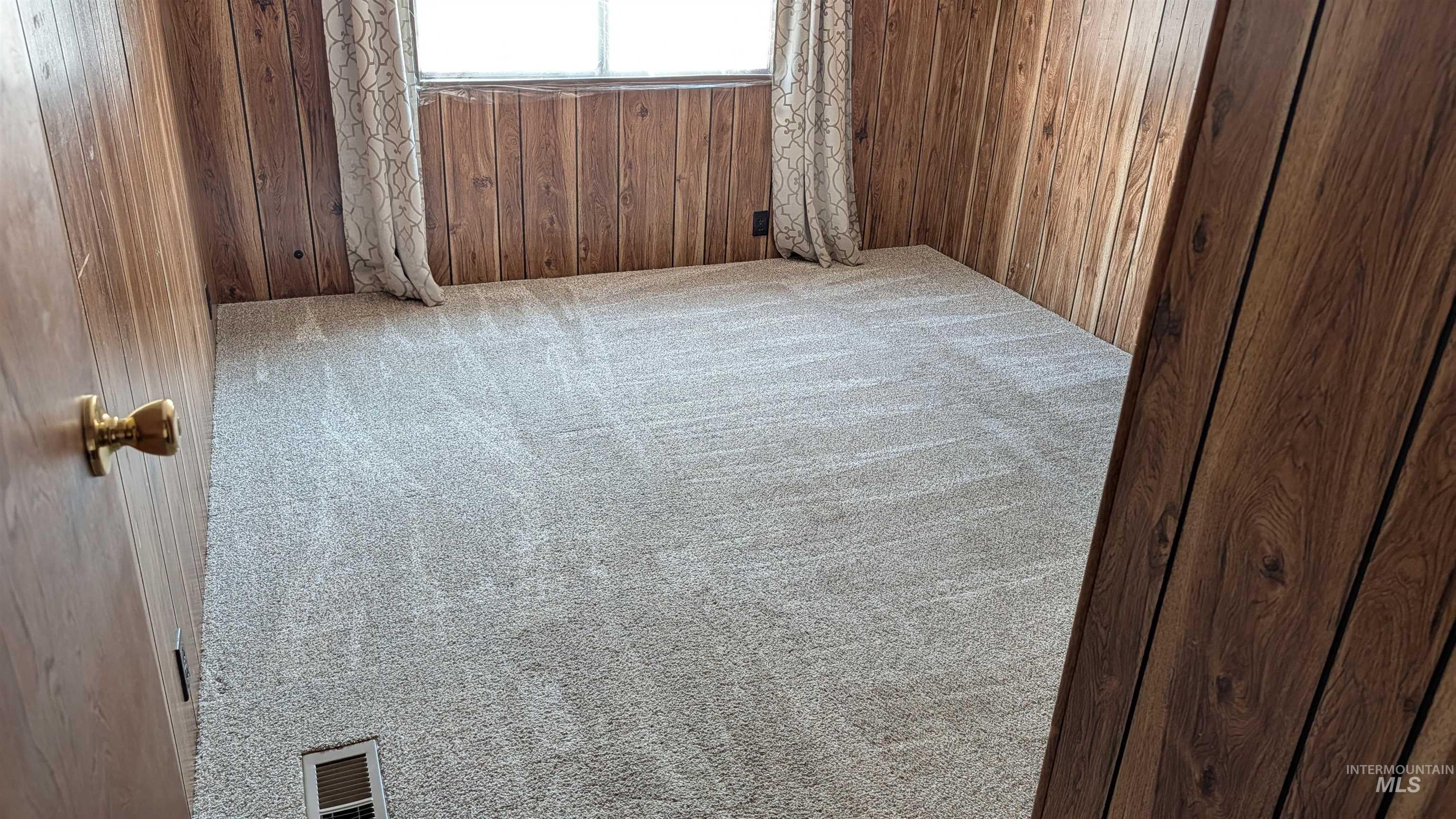 10165 West Claudia Road Boise, ID 83714 - Photo 27 of 30 Light-toned carpeting with wood-panel walls