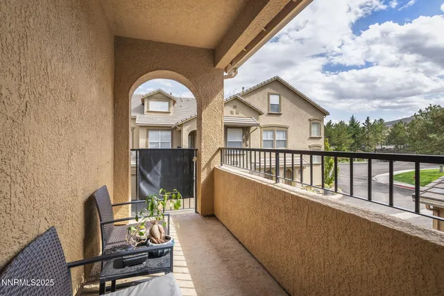 a view of a chair and tables in the balcony