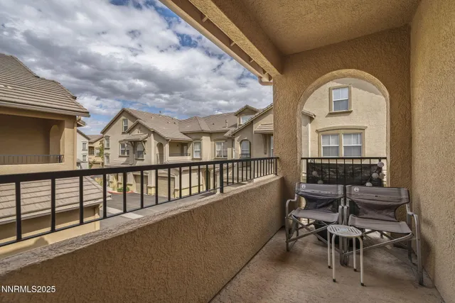 a view of a chairs and table in a balcony