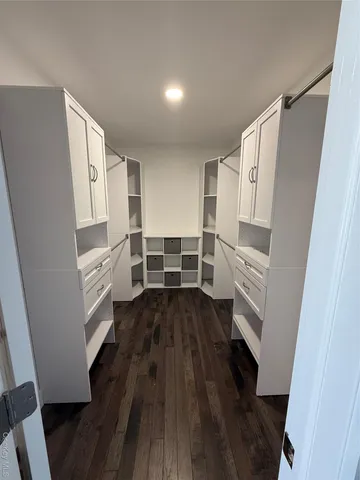 a kitchen with wooden floors and white appliances