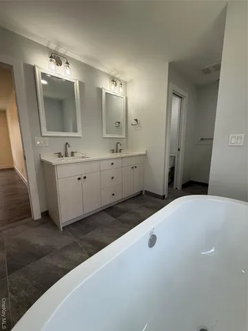 a bathroom with a double vanity sink and mirror