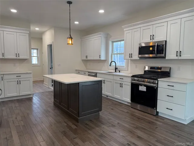 a kitchen with a sink stove and wooden cabinets