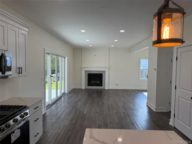 an entryway with wooden floor and brick walls