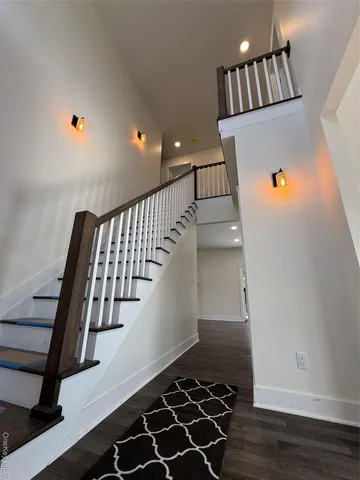 a view of entryway with stairs and wooden floor
