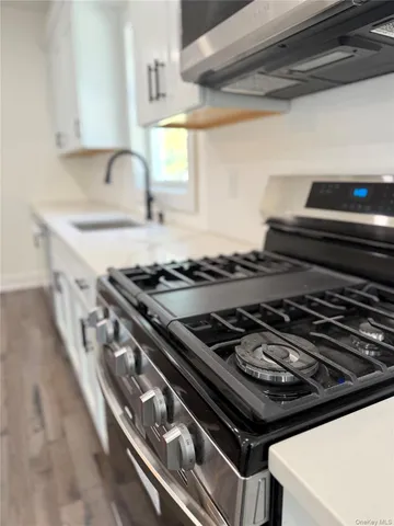 a stove top oven sitting inside of a kitchen