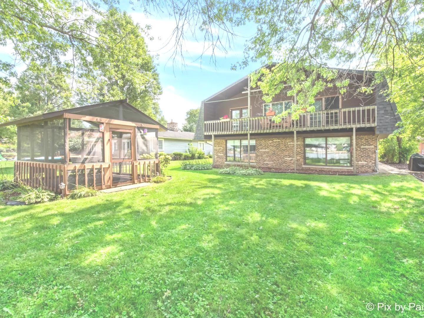 a house view with swimming pool in front of it