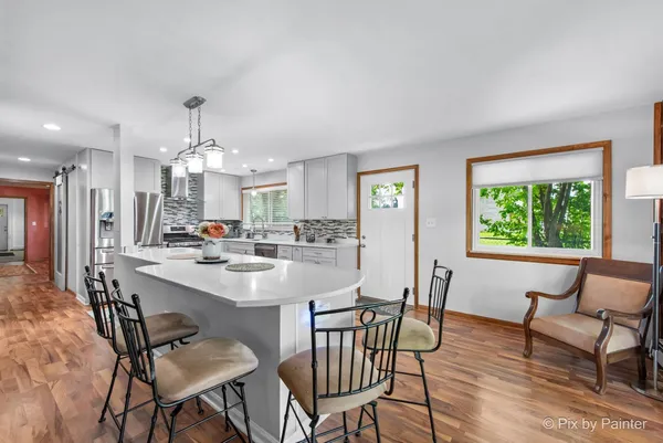 a kitchen with counter top space a sink appliances and cabinets