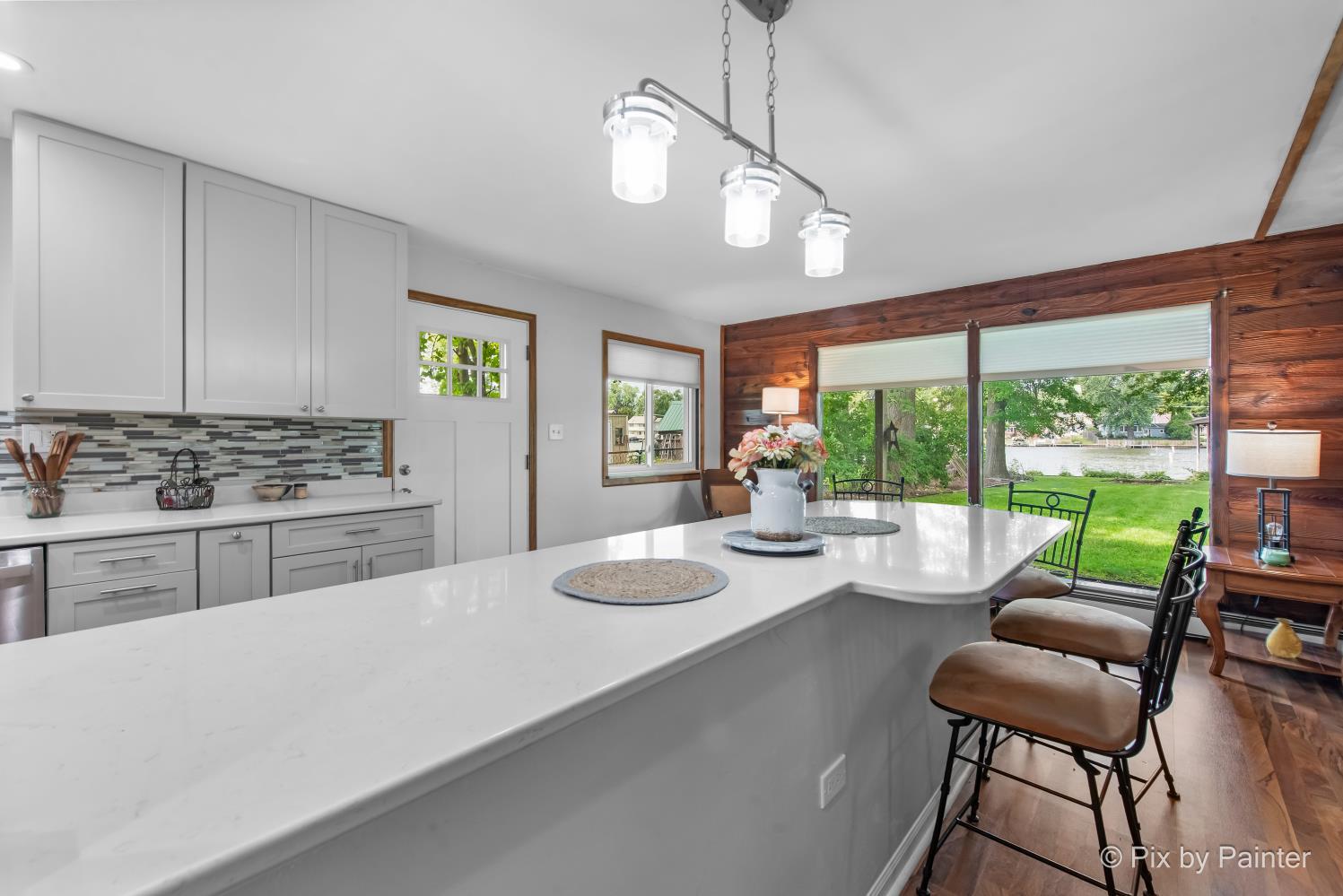 1423 North River Road McHenry, IL 60051 - Photo 17 of 49 a kitchen with stainless steel appliances kitchen island granite countertop a stove a sink a dining table and chairs with the view of kitchen