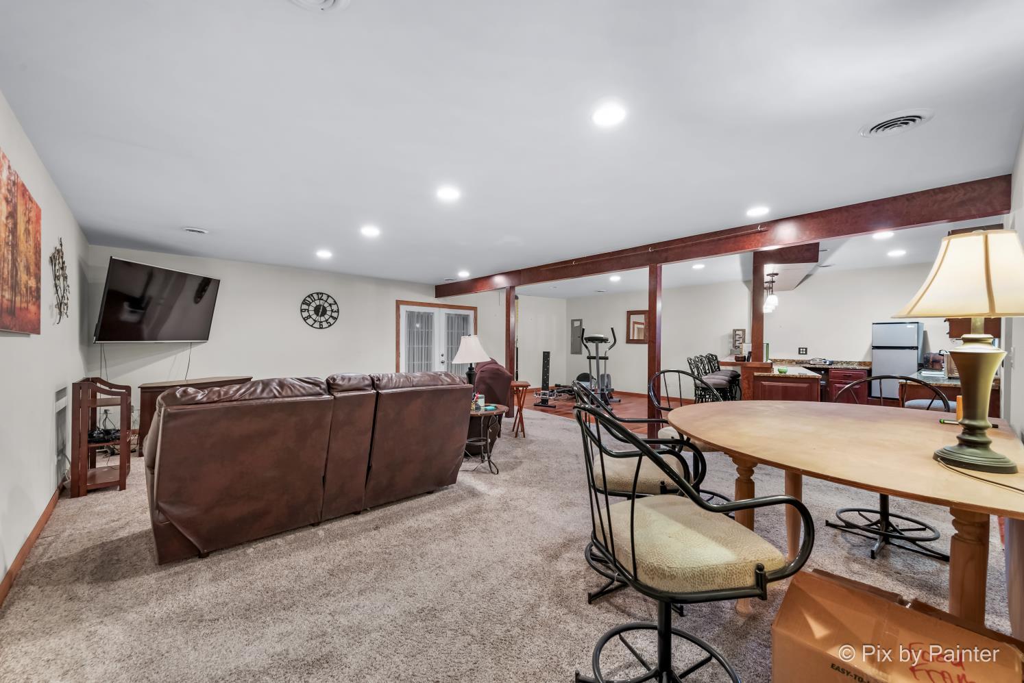 1423 North River Road McHenry, IL 60051 - Photo 24 of 49 a living room with furniture a flat screen tv and a large window