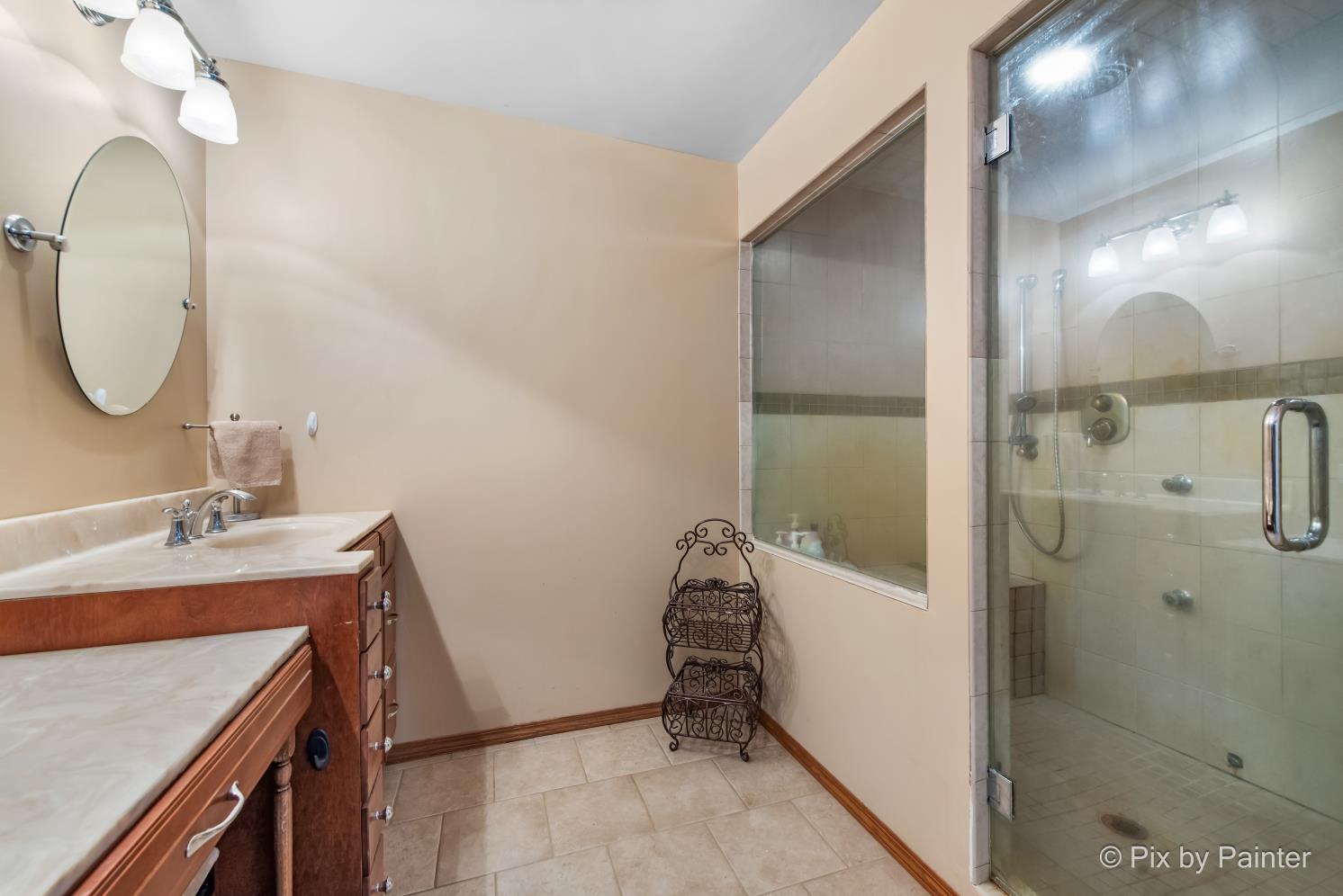 1423 North River Road McHenry, IL 60051 - Photo 27 of 49 a bathroom with a sink and a mirror
