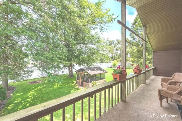 a view of a house with backyard and a sitting area