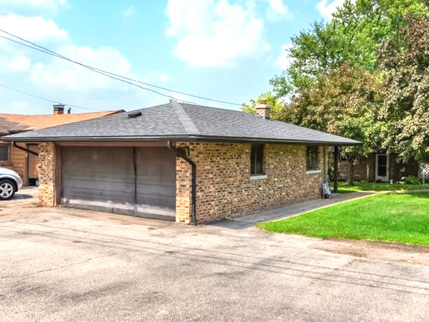 1423 North River Road McHenry, IL 60051 - Photo 45 of 49 a front view of a house with a garden and yard