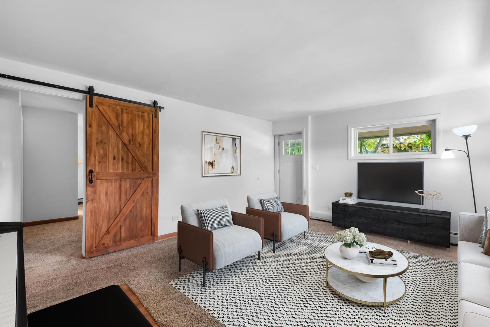 1423 North River Road McHenry, IL 60051 - Photo 8 of 49 a living room with furniture and a flat screen tv