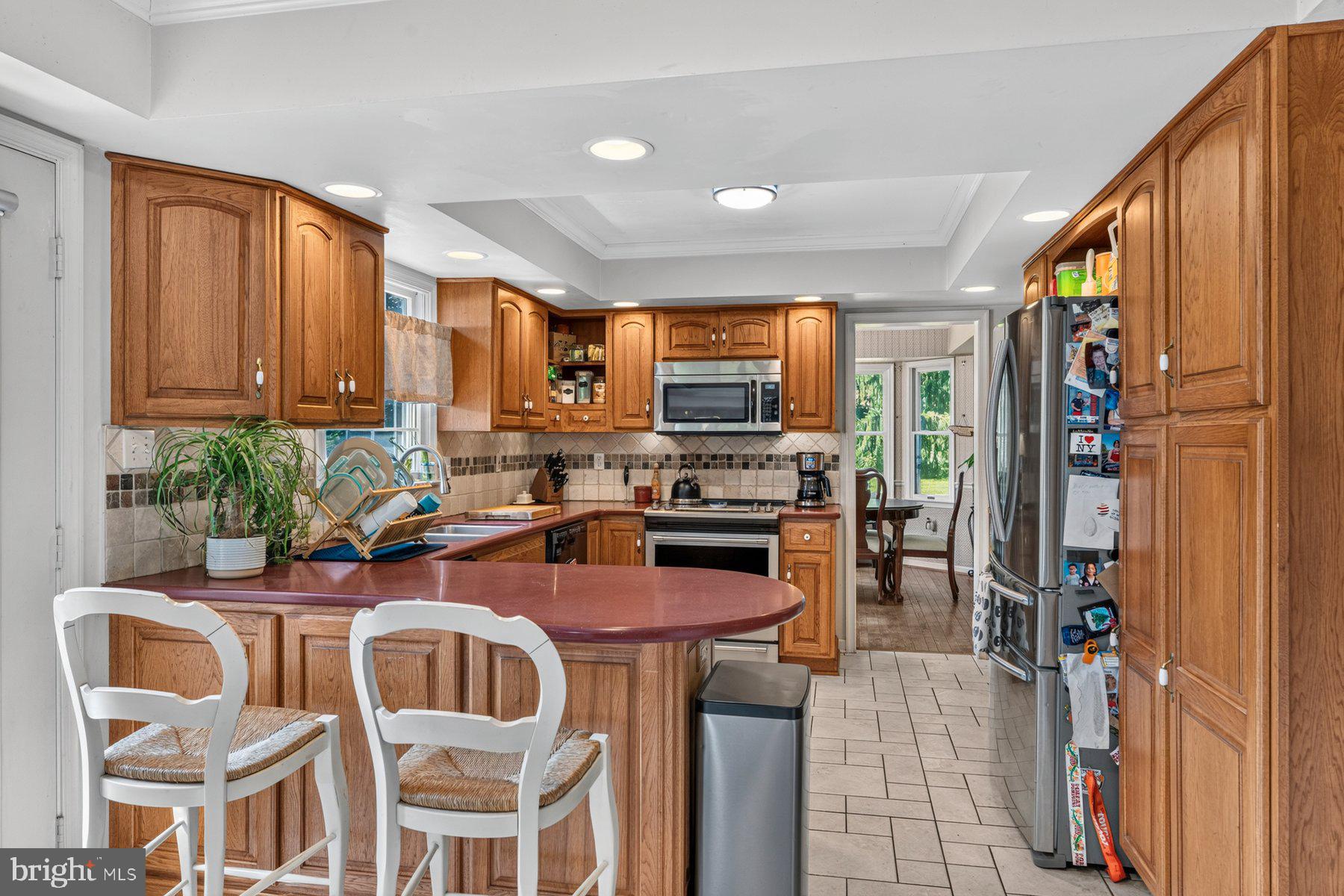 49 Rockland Road Westminster, MD 21158 - Photo 40 of 66 a kitchen with stainless steel appliances granite countertop a refrigerator a stove top oven a sink dishwasher and cabinets with wooden floor