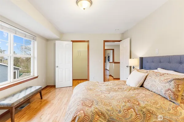 a bedroom with a large bed and a large window