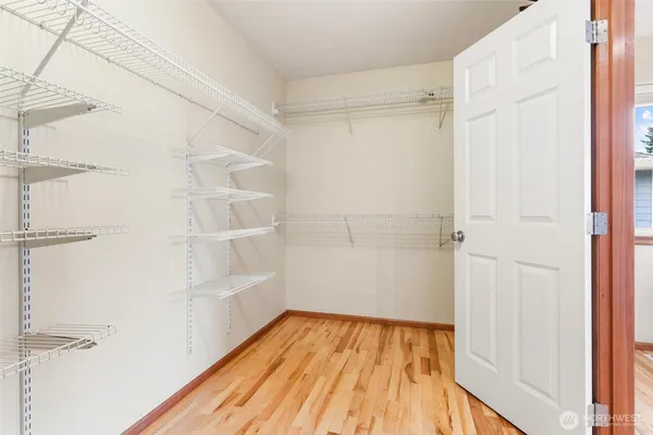 a view of walk in closet with empty racks