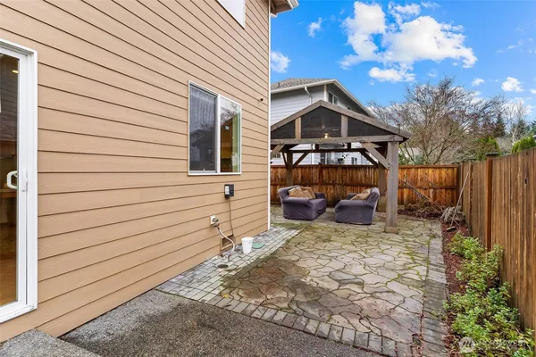 a view of a house with wooden fence