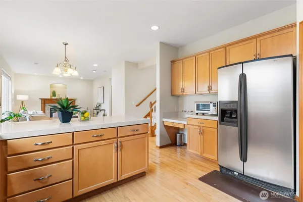 a kitchen with stainless steel appliances a refrigerator sink and cabinets