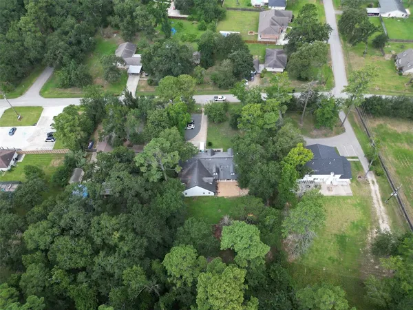 an aerial view of a house with a yard and outdoor seating