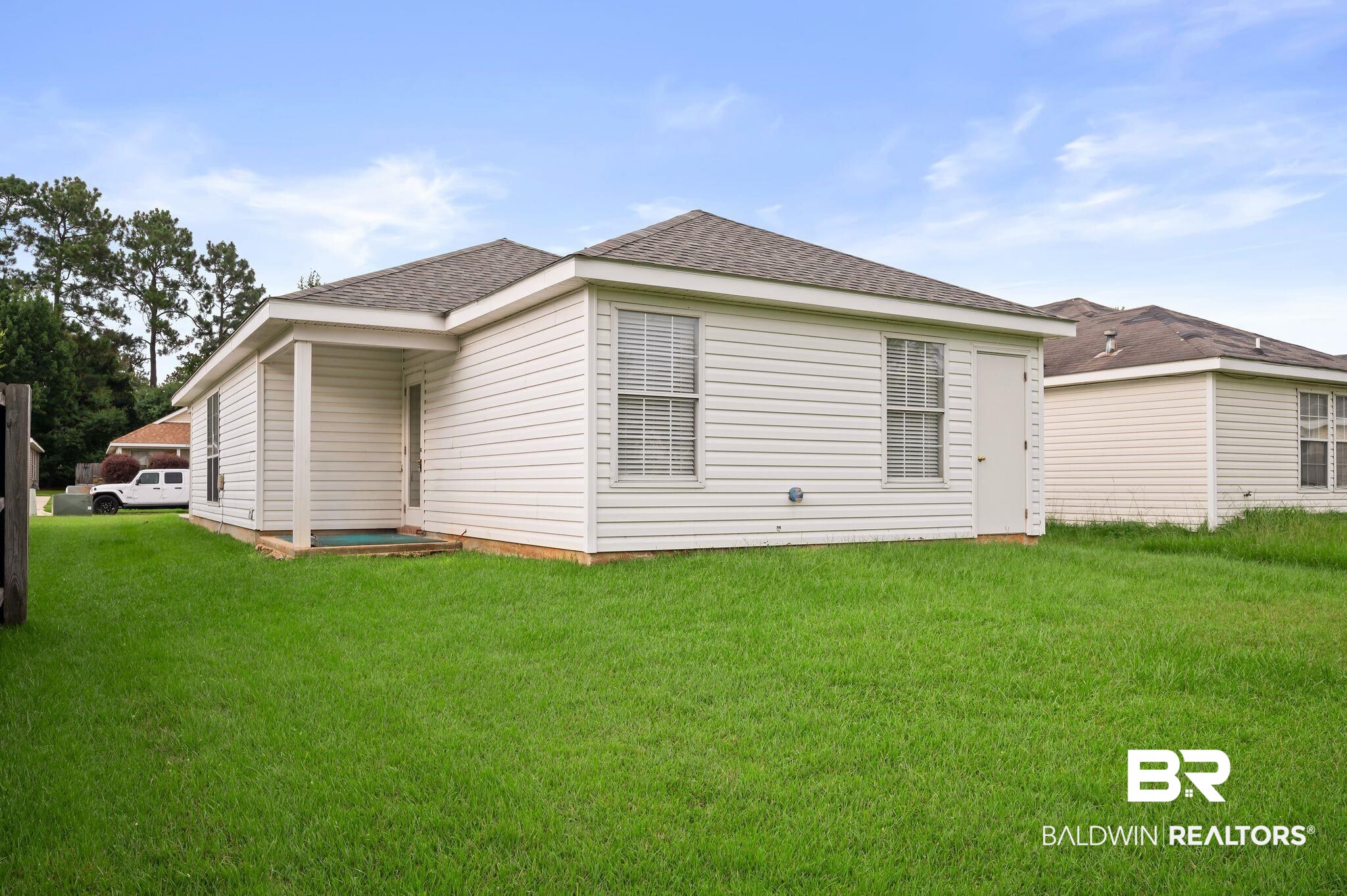 8901 Fall Court Mobile, AL 36695 - Photo 21 of 23 Back of property with a yard and a shingled roof