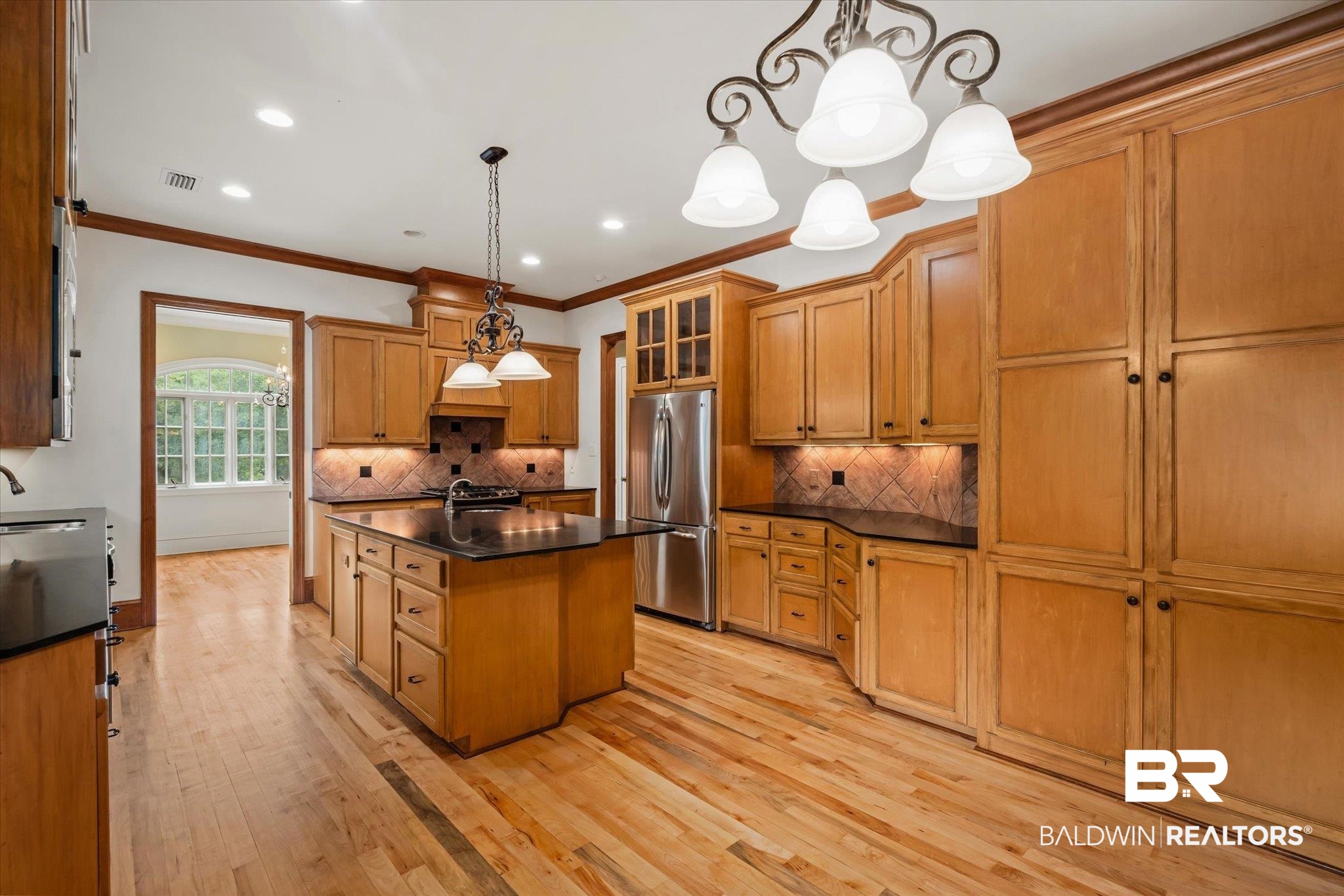 812 Country Club Court Mobile, AL 36609 - Photo 6 of 34 Kitchen with pendant lighting, stainless steel appliances, light hardwood / wood-style flooring, and a center island with sink