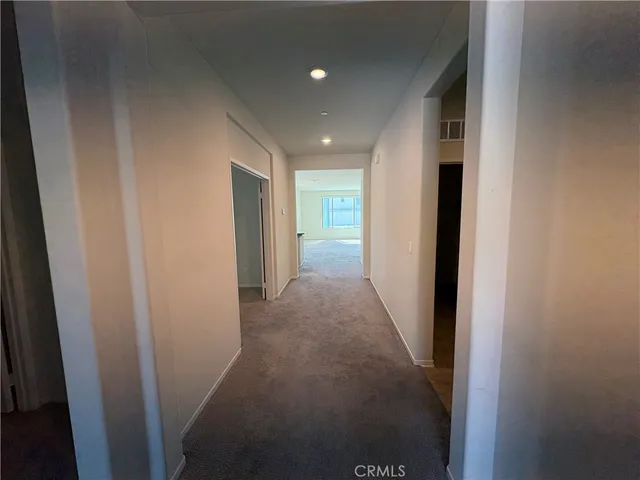a view of hallway with wooden floor
