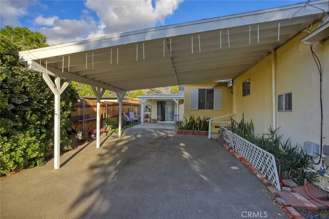 a living room with furniture a large window and wooden floors