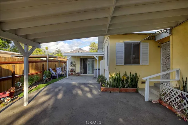 a living room with furniture a rug and a clock
