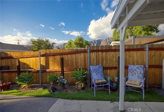 a view of a chairs and table in backyard of the house