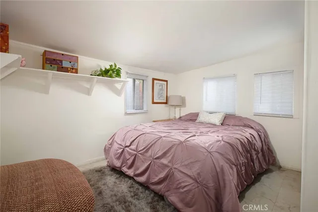 a front view of a house with a garden and trees