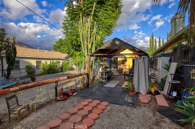 a view of a chairs and tables in the patio and a fountain