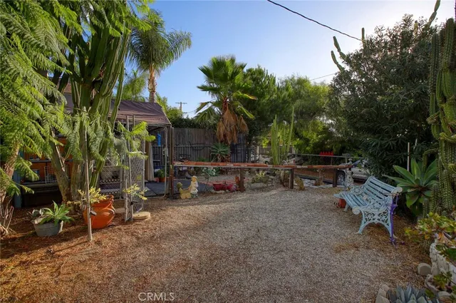 a view of a house with brick walls and a small yard