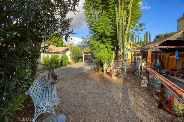 a view of a house with a yard and tree s