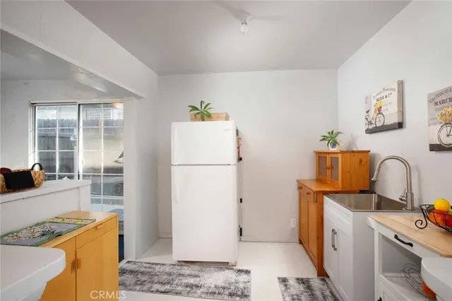 a living room with furniture a rug and white walls